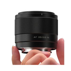 Close-up of a hand holding a Viltrox AF 20mm f/2.8 lens for Sony E, with "AF 20/2.8 FE" on the side, against a white background.