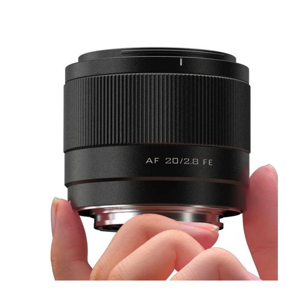 Close-up of a hand holding a Viltrox AF 20mm f/2.8 lens for Sony E, with "AF 20/2.8 FE" on the side, against a white background.