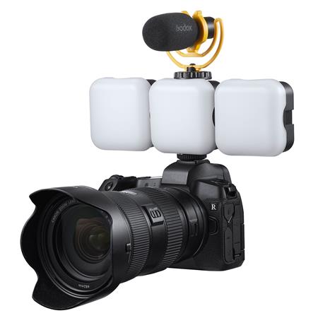 A digital camera with a large lens, three Godox Litemons LED6R RGB lights mounted on top, and an external microphone mounted above the lights.