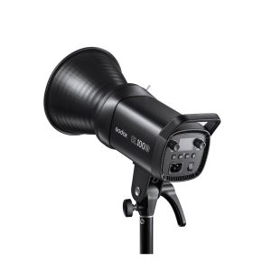The black Godox LED SL100Bi Bi-Color LED luminaire is mounted on a stand, pictured from the back, where the control buttons and handle are visible. It features a large reflector and a robust construction, ideal for photography or video shooting.