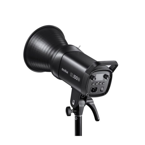 The black Godox LED SL100Bi Bi-Color LED luminaire is mounted on a stand, pictured from the back, where the control buttons and handle are visible. It features a large reflector and a robust construction, ideal for photography or video shooting.