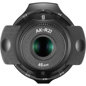 Close-up of the projector attachment of the Godox AK-R21 flashlight with 65 mm lens with black cover and white markings, taken from above to highlight the glass element and surrounding details.