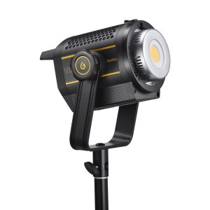 The black and yellow Godox VL200II LED video light is mounted on a tripod and displayed from the side, revealing a power button on the arm and a circular LED panel at the front.