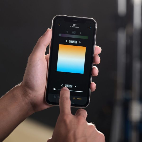 A person uses a smartphone to adjust the colour temperature to 5600K in the Godox VL200II Led Video Light's lighting control app, and the app displays a blue to orange shade.