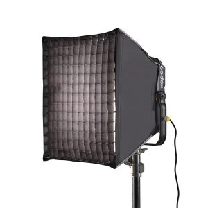 The Godox P600BHS22 Rectangle Grid Softbox is mounted on a luminaire base and illuminates from the left. A power cord is dangling from the luminaire.