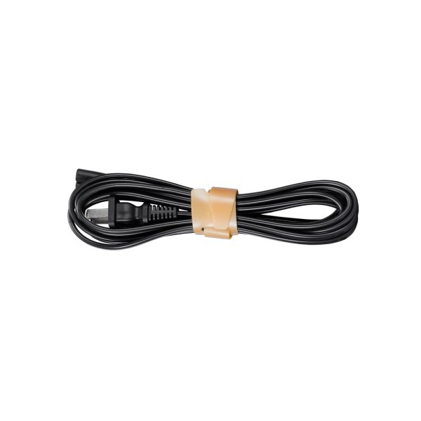 Musta sähköjohto Godox KNOWLED LDX100BI Panel Light Bi-Color -paneelivalaisimelle, siististi käärittynä ja kiinnitettynä ruskealla tarranauhalla.