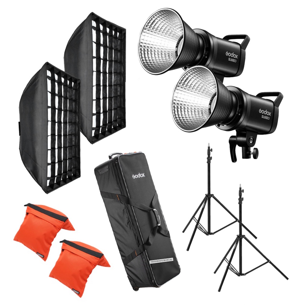 The Godox SL60IID Duo Pro Kit is a complete photographic lighting kit with two LED lights, two softboxes with grids, two orange sandbags, two light stands and a black carrying case.