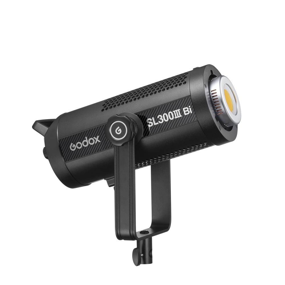 The Godox SL300IIIBi Bi Color LED Light is a black, cylindrical studio light with vented sides and a sturdy mounting frame, shown slightly angled against a white background.