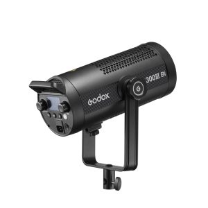 The black Godox SL300IIIBi Bi Color LED Light (300W) with control buttons, display and ventilated body is mounted on a yoke bracket and displayed against a white background.