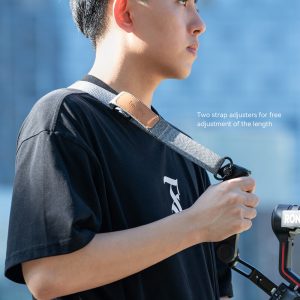 A person in black wearing a SmallRig 4118B weight reducing shoulder strap for the DJI RS 3 / RS 3 Pro / RS 2 / RSC 2. Text in picture.