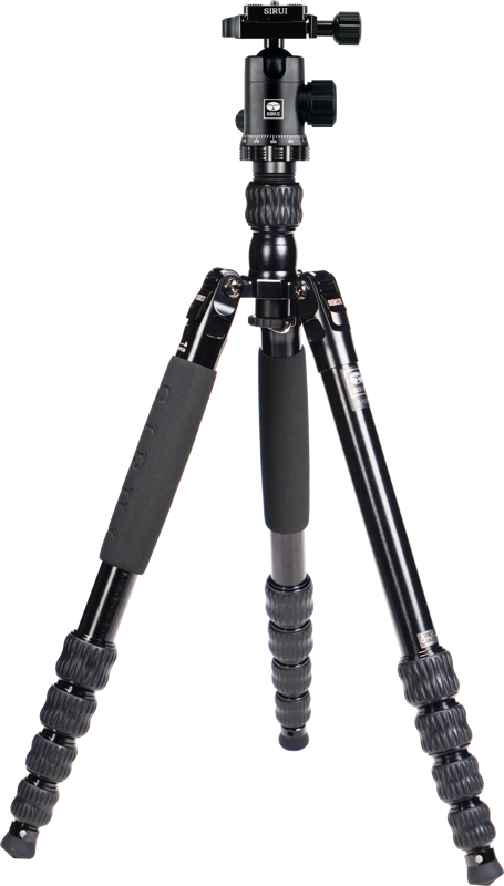 The Sirui Traveler Tripod Kit T-1005+E-10, a black tripod tripod tripod with padded handles and adjustable screw-lock leg sections, is fully extended against a white background.