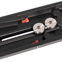 Sirui Quick Release Plate VP-SH15 -pikalevy on musta metallilevy, jossa on kaksi hopeaa kiinnitysruuvia, kultainen tappi, punainen lukitusmekanismi ja kaiverrettu linssin suuntausmerkintä.
