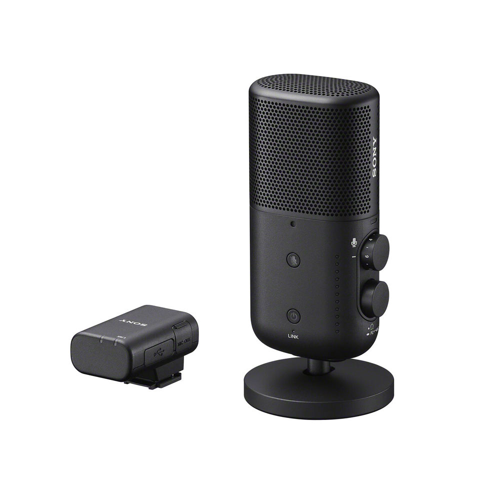 The Sony ECM-S1 wireless microphone is a black desktop microphone with a cylindrical body and side control knobs, pictured next to a compact wireless transmitter against a white background.