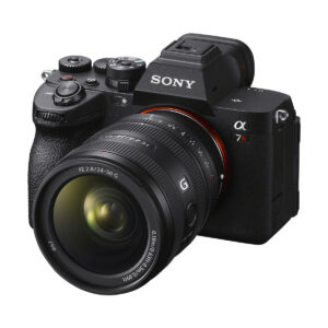 Black Sony Alpha 7R IV mirrorless camera with Sony FE 24-50mm f/2.8 G lens attached, turned to the left to reveal detailed top and side controls; includes €100 cashback on the lens.