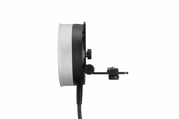 Sivunäkymä Godox R1200 -rengassalamapäästä AD1200Pro:lle, jossa on pyöreä muotoilu mustalla ja hopeisella kehyksellä, kiinnitetty kiinnike ja virtajohto, joka ulottuu alaspäin valkoista taustaa vasten.