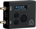 The ATOMOS Ultrasync One is a black electronic device with a small display for time and settings, round control buttons, USB port, gold-coloured input and output connectors and the Atomos logo in the bottom right corner.