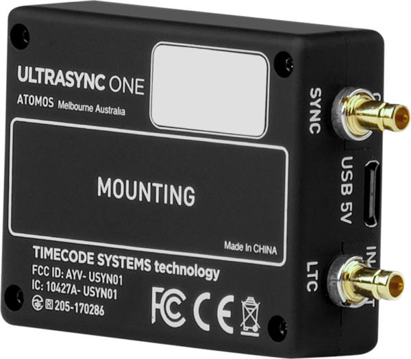 The black ATOMOS UltraSync One has SYNC, USB 5V and LTC side ports and a white front label with mounting and technical information.
