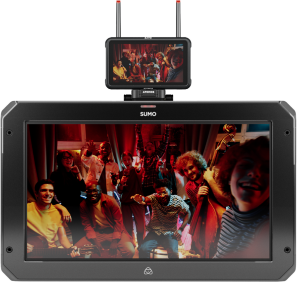 800q-03_125019 The small ATOMOS Z-Mount monitor sits on top of the larger screen, and both show a happy crowd of people posing and smiling in a warmly lit room, some holding musical instruments.