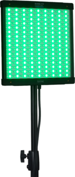 NANLITE PavoSlim 60C RGBWW LED panel, a rectangular light on a stand, displays bright green with a grid of individual LEDs and has a wire hanging from the back.
