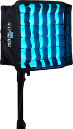 The NANLITE PavoSlim 60C RGBWW LED panel with rectangular design and square softbox emits bright blue light and is mounted on a black stand against a plain background.