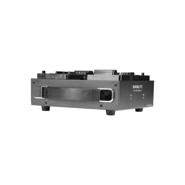 The black NANLITE battery charger for the 26 V V-mount twin battery with handle, four short legs and top and side panel ports with buttons is visible against a white background.