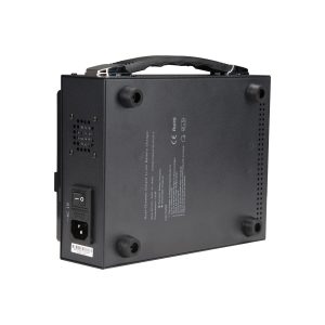 The NANLITE Battery Charger Dual for 26V V-mount battery is a black device from the bottom with ventilation holes, power switch, socket, carrying handle on top, four rubber feet and product information printed on the bottom.
