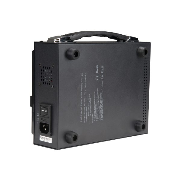 The NANLITE Battery Charger Dual for 26V V-mount battery is a black device from the bottom with ventilation holes, power switch, socket, carrying handle on top, four rubber feet and product information printed on the bottom.