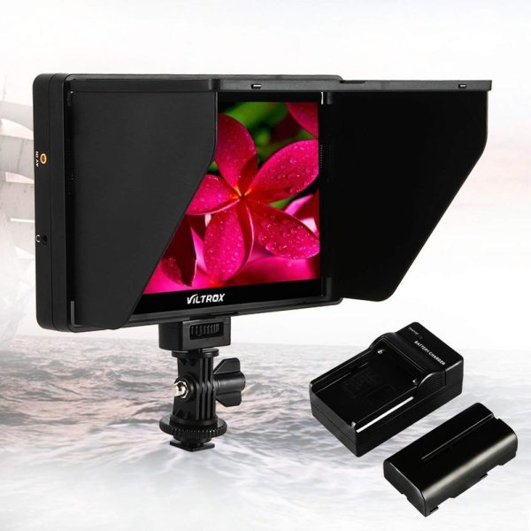 The Viltrox DC 70 HD LCD 7" monitor with foldable sun dome shows a close-up of a pink flower. Next to the monitor is the battery and charger, all against a light background.