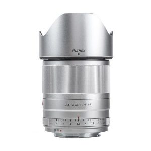 The silver Viltrox AF 33mm f/1.4 lens for Fuji X stands upright against a white background, with a focus ring and backlight protection.