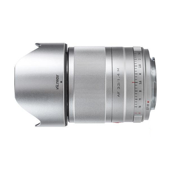 Silver Viltrox AF 33mm f/1.4 lens for Fuji X with brushed focus ring, aperture markings and attached hood, shot from the side on a white background.