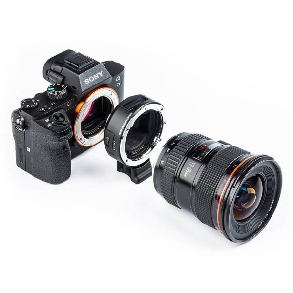 Sony Alpha camera, Viltrox EF - Sony E adapter and camera lens are lined up on a white background, with the adapter placed between the camera and lens.