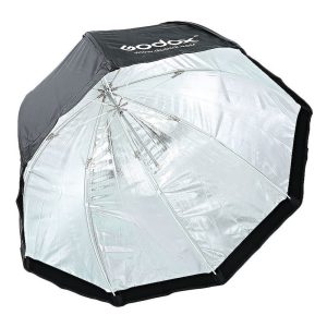 The Godox SB-UBW80 Softbox with Octa umbrella 80cm is a large, silver-coloured, reflective octagonal softbox with a black outer edge and the Godox logo.