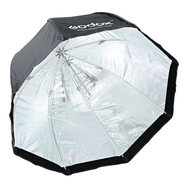 The Godox SB-UBW80 Softbox with Octa umbrella 80cm is a large, silver-coloured, reflective octagonal softbox with a black outer edge and the Godox logo.