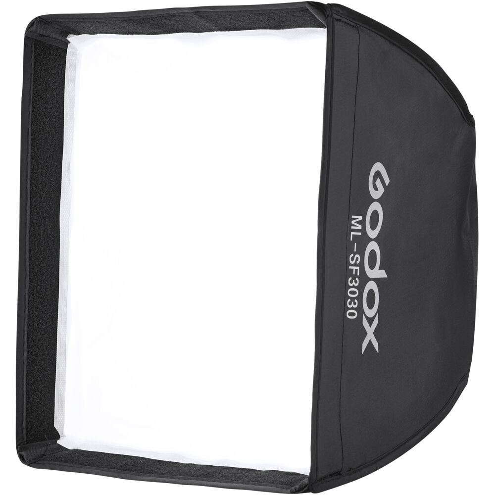 Godox Softbox 30x30cm ML30 & ML30Bi -valaisimille on kuvattu ylhäältä päin, ja siinä on valkoinen diffuusorin etuosa ja musta ulkokuori, jonka kylkeen on painettu tuotteen nimi.