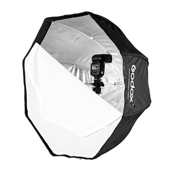 The Godox SB-UBW80 Softbox with Octa Umbrella 80cm is a black, octagonal softbox with silver interior and white diffuser, designed for professional photographic lighting and compatible with installed Godox flash units.