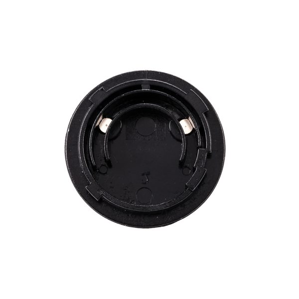 Close-up of the Viltrox AC Adapter VL400T / VL600T's round, black plastic battery holder, built for a coin battery and with two internal metal contacts for electrical connection.