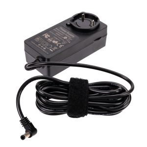 The Viltrox VL400T / VL600T power supply is a black rectangular unit with a European plug, with technical information and safety symbols. The power cord connected to it is neatly twisted and attached with Velcro.