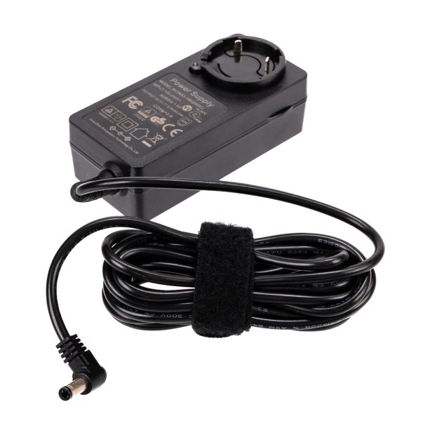 The Viltrox VL400T / VL600T power supply is a black rectangular unit with a European plug, with technical information and safety symbols. The power cord connected to it is neatly twisted and attached with Velcro.