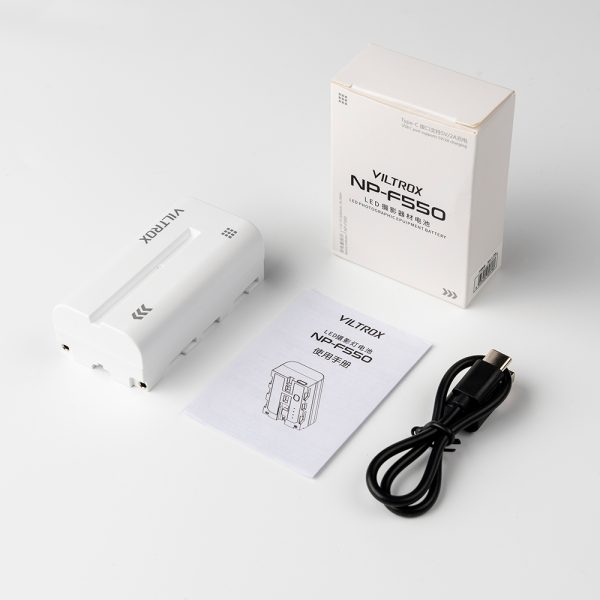 The Viltrox NP-F550 with USB-C, white product packaging, user manual and black USB cable are neatly laid out on a white surface.