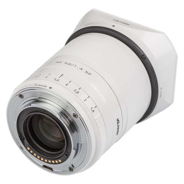 The Viltrox AF 56mm f/1.4 lens, Fuji X (Limited Edition White) is visible from the rear, with its white finish, metal mount with electronic contacts and aperture markings on the barrel.
