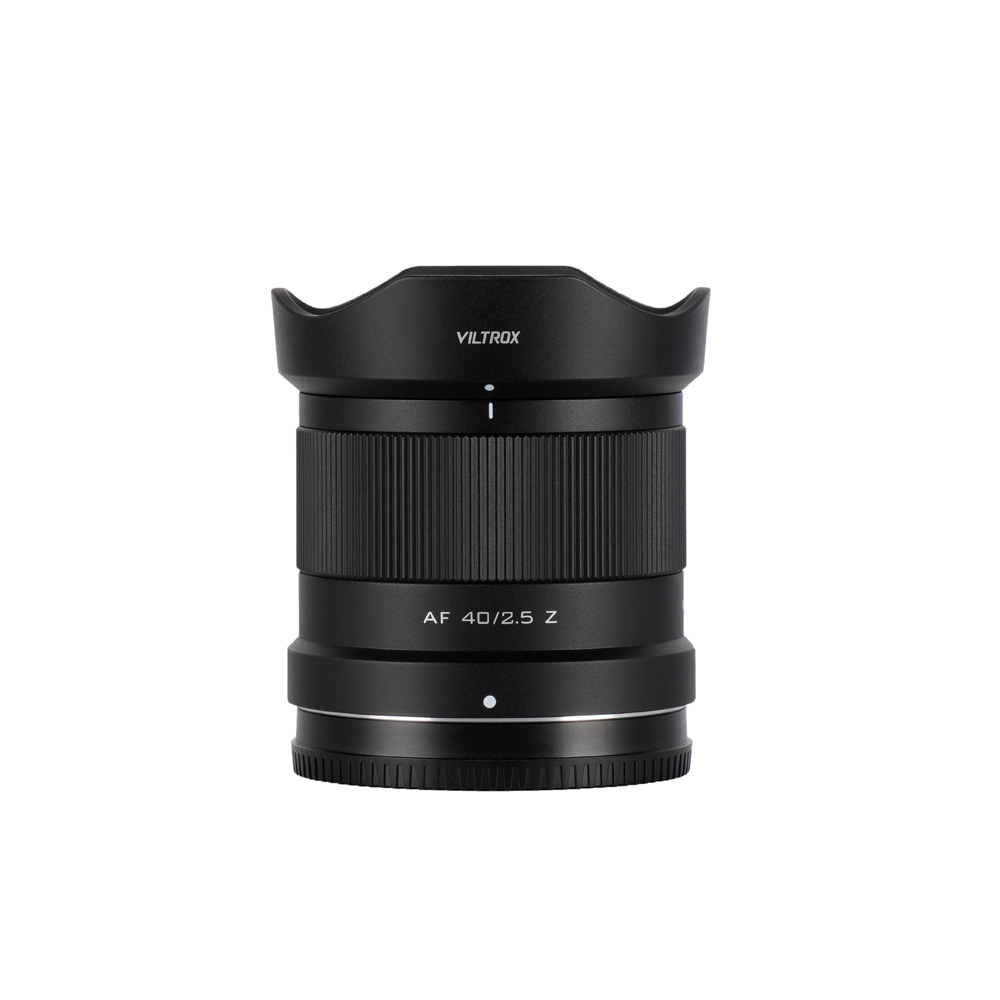 A Viltrox AF 40mm f/2.5 lens, Nikon Z stands upright against a white background, showing a black cylindrical body and grooved focus ring.
