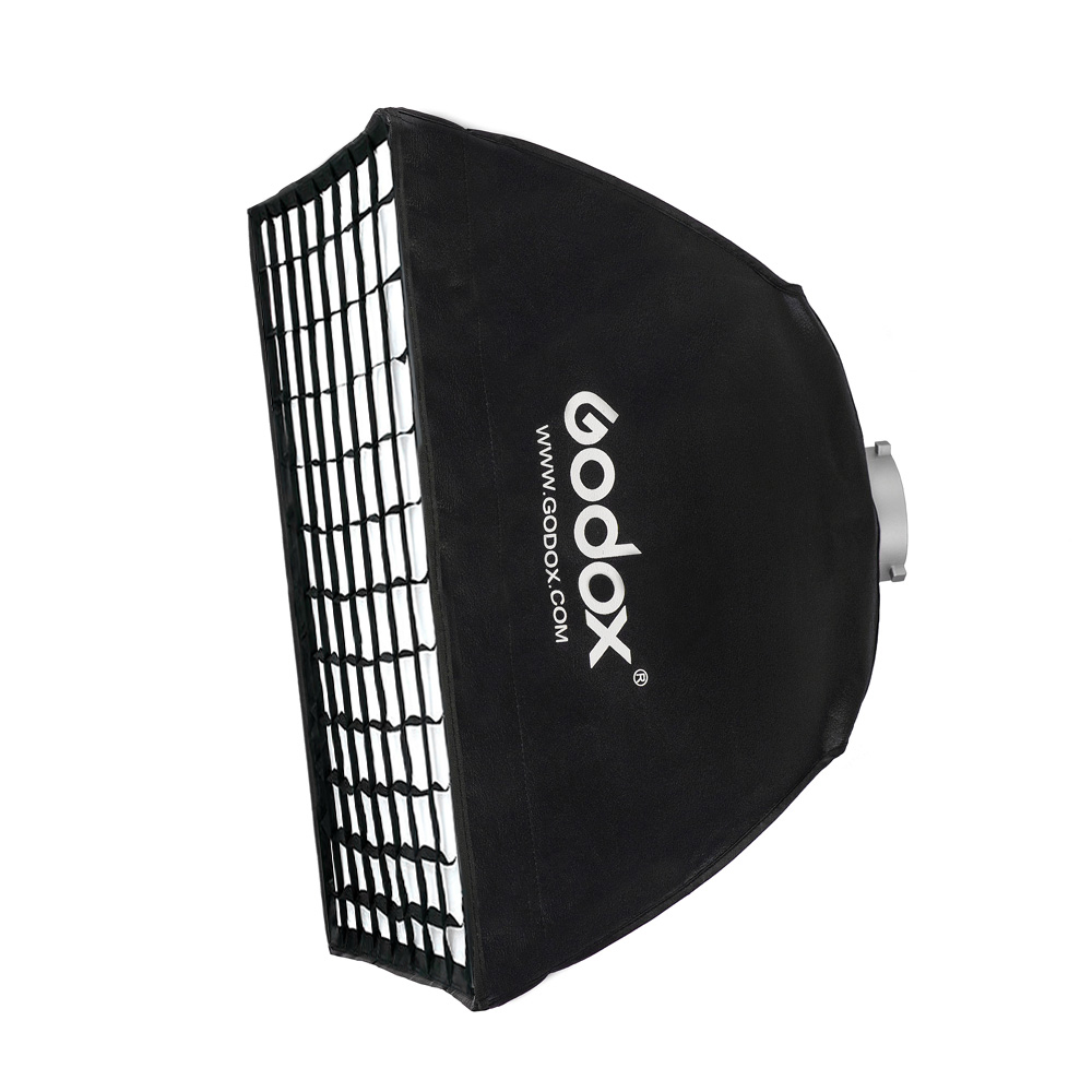 The Godox Softbox Bowens Mount + Grid 60x60cm is shown against a white background, with the Godox brand and website displayed on the black surface, and its grid mount is visible for studio lighting use.