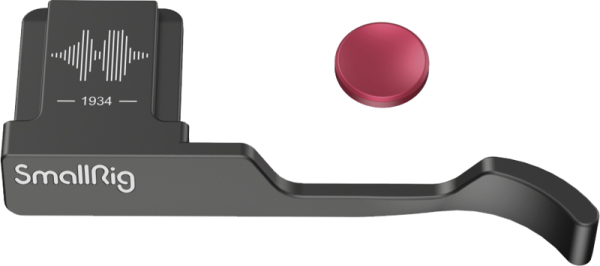 Black metal SmallRig 4559 mirror grip for Fujifilm X100VI/X100V with curved handle, sound altography, "1934" marking and separate round red button.