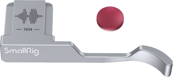 The SmallRig 4566 Thumb Grip for Fujifilm X100VI/X100V (silver) features a curved grip with "1934" engraved on it and a sound wave placed next to a round red button.
