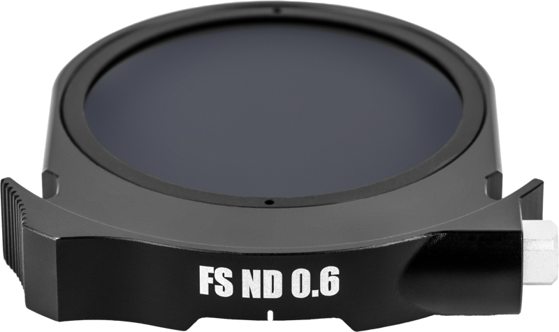 Close-up of a round black NiSi Cine Drop-In filter FS ND4 (2 Stop) in a holder with the filter name marked on the edge, against a light background.