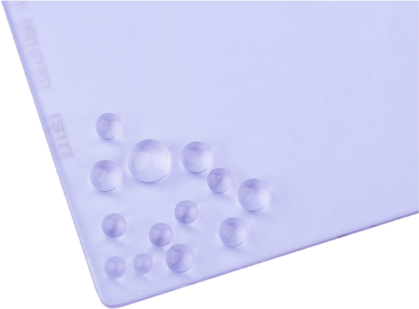 Close-up of the NiSi Filter Natural Night 100x100mm, showing its smooth, shiny, translucent, light purple surface with water droplets accumulated in one corner.