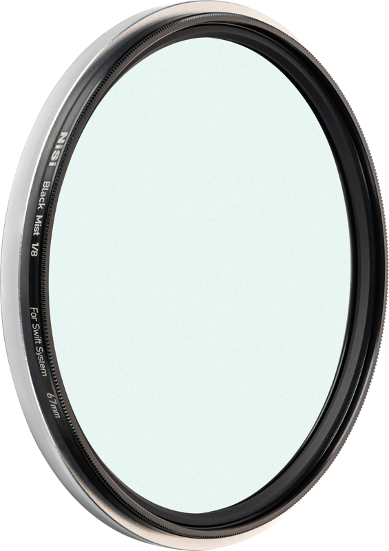 A close-up of the NiSi Filter Swift System Black Mist 1/8 67mm diffusion filter shows its thin black and silver frame against a light background.