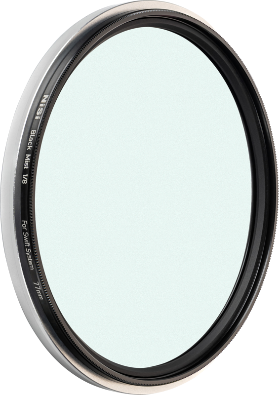 NiSi Filter Swift System Black Mist 1/8 77mm diffusion filter close-up shows its thin black metal ring, clear centre glass and edge detail.