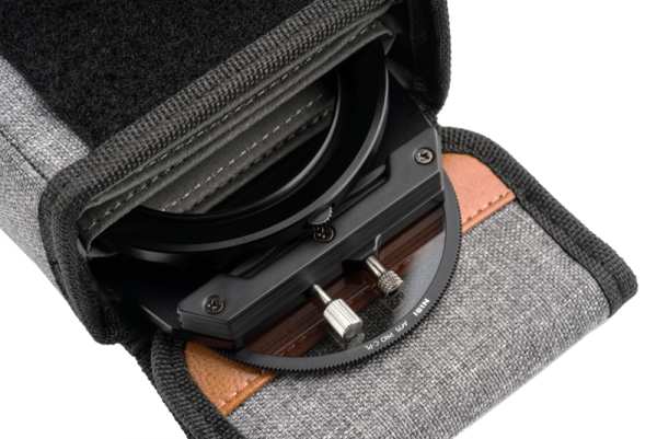 Close-up of the grey NiSi bag for the M75 holder and filters, partially open to reveal the lens filter holder with adjustment knobs and circular filter.