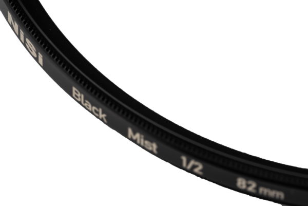 Close-up of the NiSi filter Black Mist 1/2 52mm diffusion filter, partially visible against a white background.